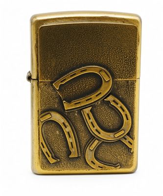 Zippo Horseshoe Brass Lighter, 2008. A Zippo regular-size lighter with embossed horseshoe motif 