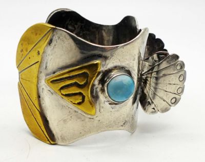 SOUTHWESTERN STERLING WATCH CUFF. 50DWT, 7IN AROUND WITH GAP, HAS A GOLD PLATED DESIGN WITH 2 