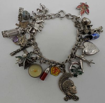STERLING CHARM BRACELET - LOADED w/CHARMS. 31.5DWT, 7 1/2IN IN LENGTH,20 CHARMS , STAMPED 