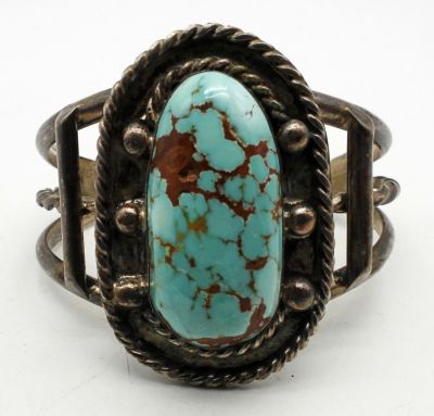 TURQUOISE STERLING CUFF BRACELET. 37.6DWT, TURQUOISE IN THE CENTER WITH STERLING DESIGN AROUND 