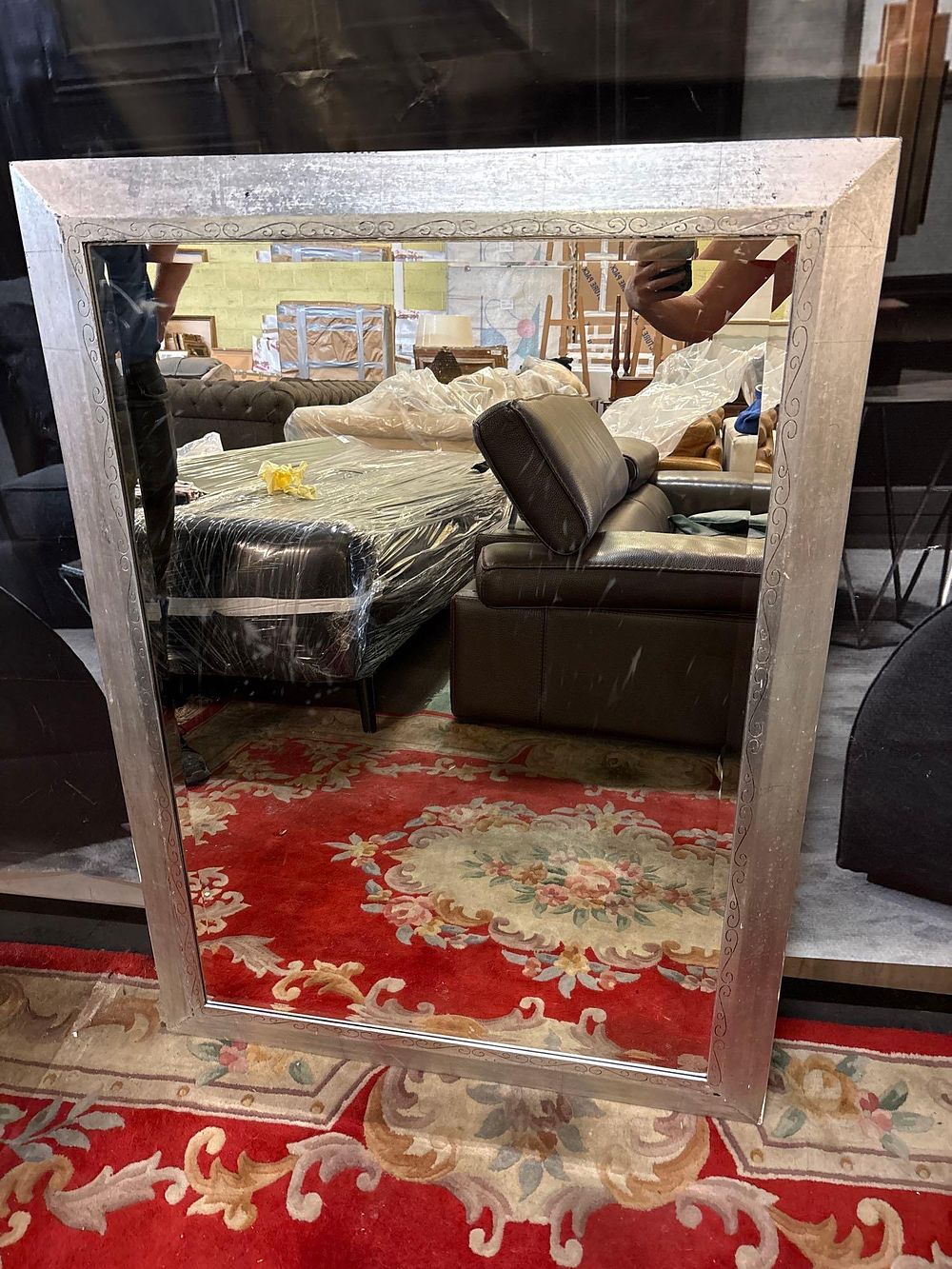 Lot 155: * A large contemporary bevelled mirror in silver painted and decorated frame 86 x 118cm