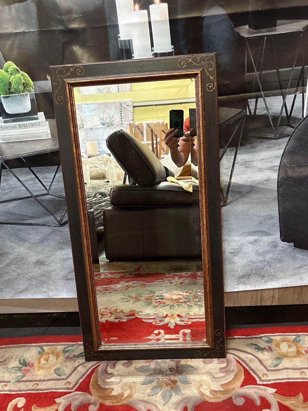 Lot 184: * A rectangular bevelled accent mirror ebonised frame with c scroll decorative pattern 45 x 90cm