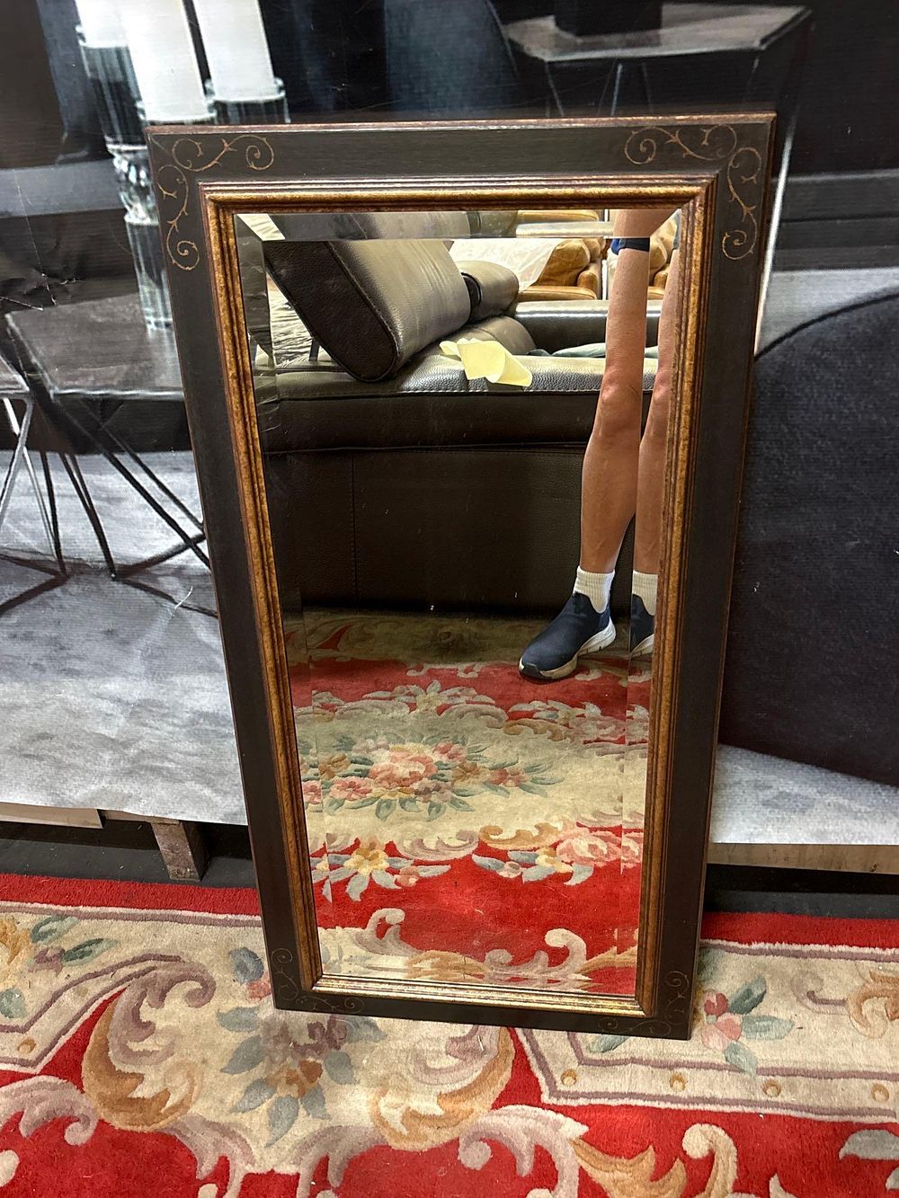 Lot 185: * A rectangular bevelled accent mirror ebonised frame with c scroll decorative pattern 45 x 90cm