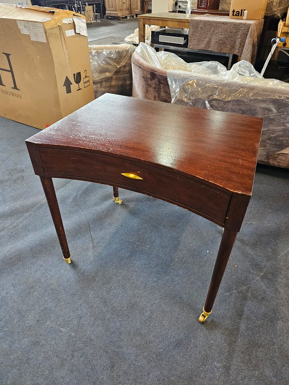 Lot 288: * Julian Chichester Mahogany Toby Style Desk with single drawer sat on brass castors 80 x 60 x 75cm