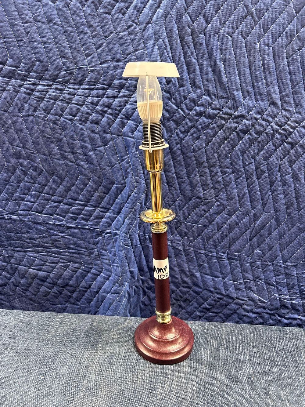 Lot 1023: * A Burgundy Wood And Brass Candlestick Form Lamp 48cm