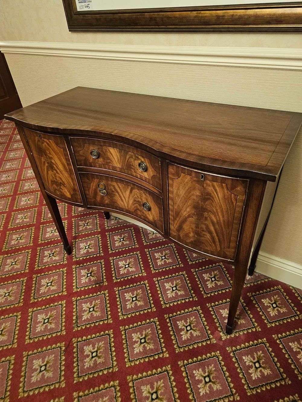 Lot 444: * A flamed mahogany two drawer two cupboard sideboard raised on spode feet