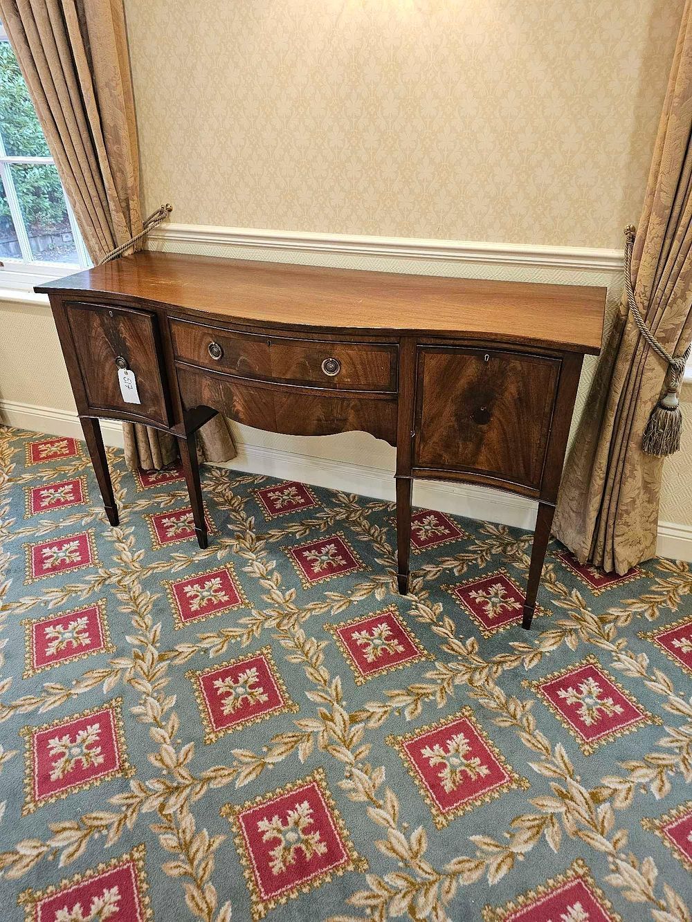 Lot 517: * A English Federal Style serpentine-front sideboard or credenza mahogany two central drawers and