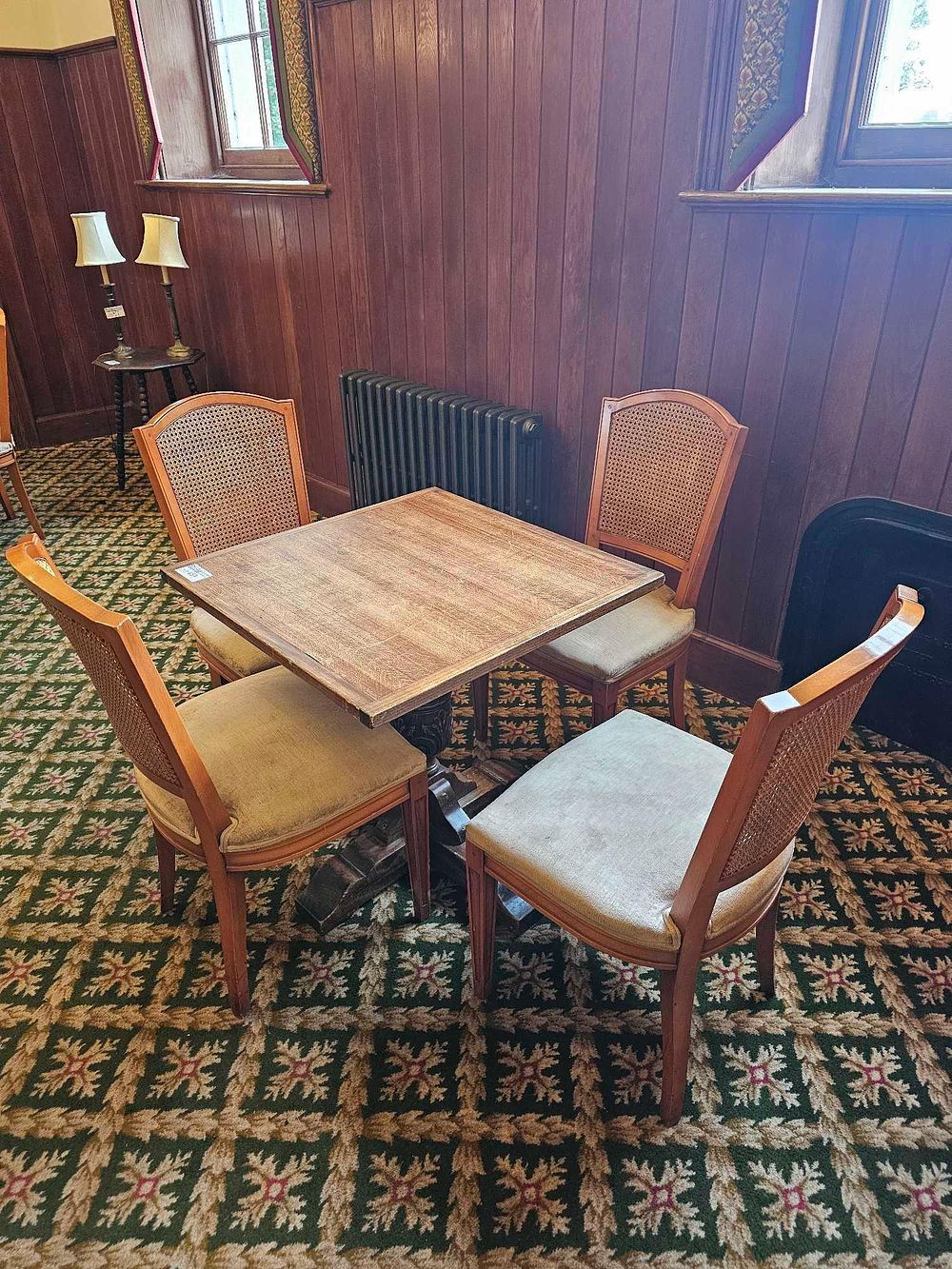 Lot 657: * Dining table and 4 chairs a square wooden table on a central wooden base and four matching wooden