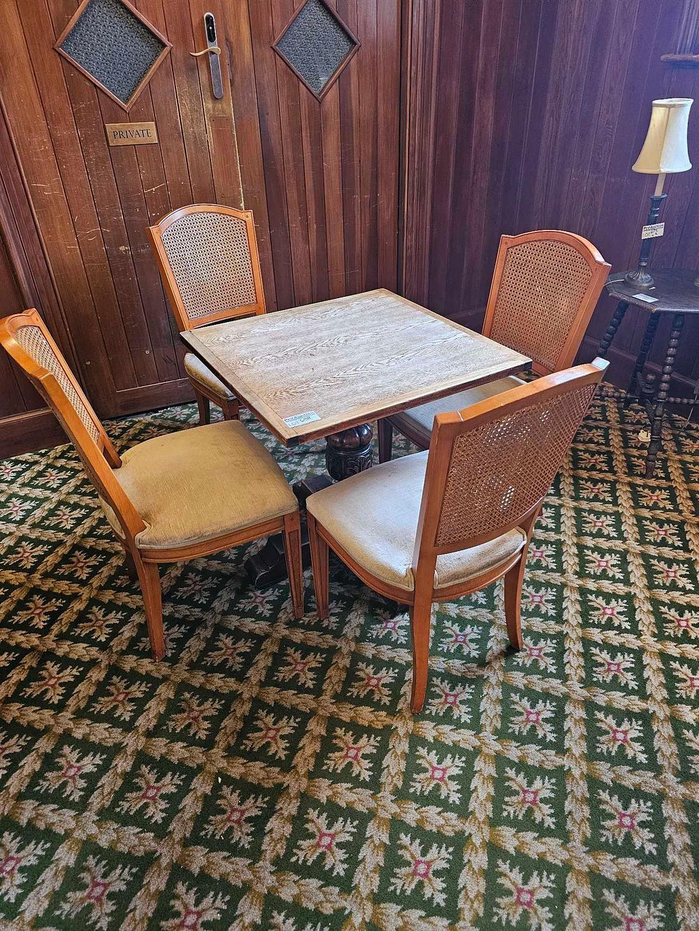 Lot 658: * Dining table and 4 chairs a square wooden table on a central wooden base and four matching wooden