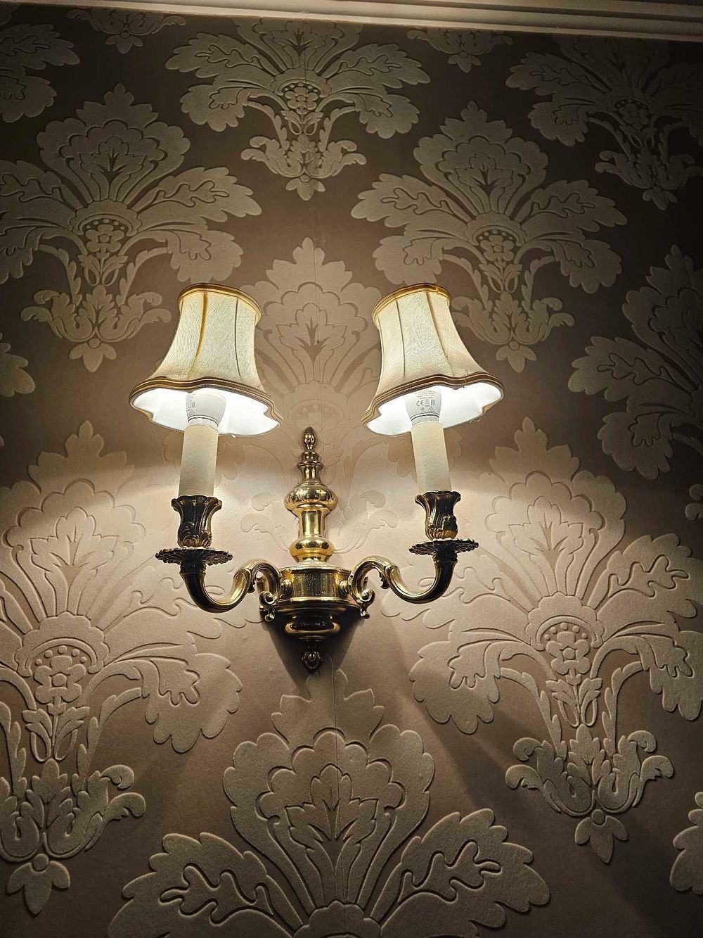 Lot 921: * A pair of Colonial Reial style double-arm wall sconces crafted from polished brass-tone metal