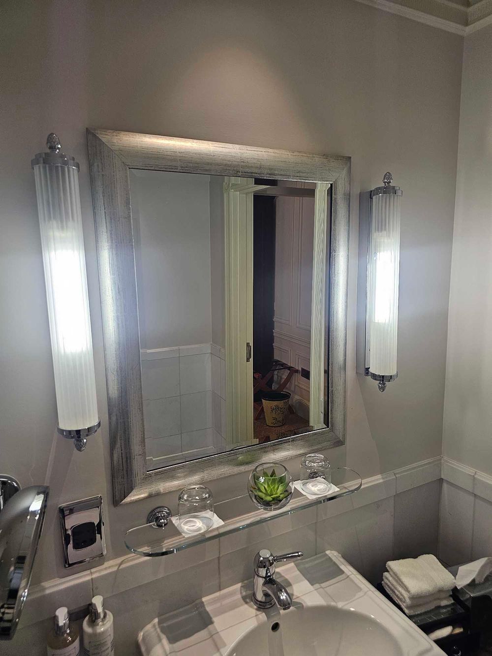 Lot 1009p: * A rectangular mirror presented in a silver painted frame with subtle decorative engraving