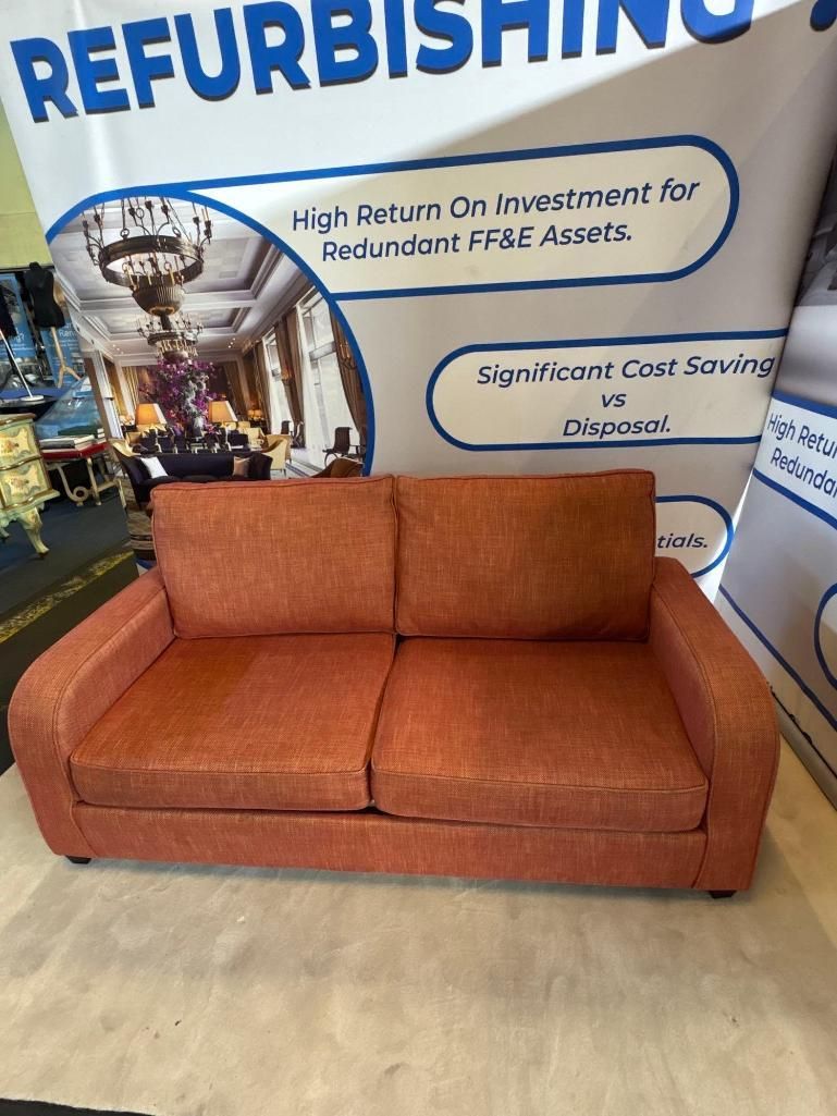 Lot 614: * Sofabed This contemporary sofabed is upholstered in a warm