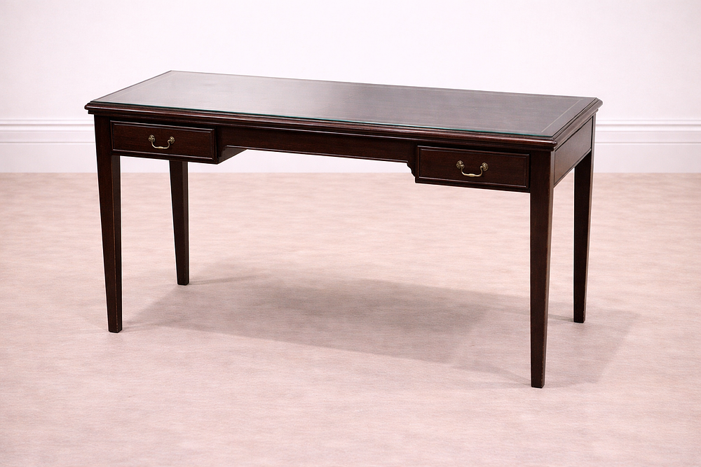 Lot 848: * A mahogany writing desk featuring a rectangular top with an inset dark leather writing surface