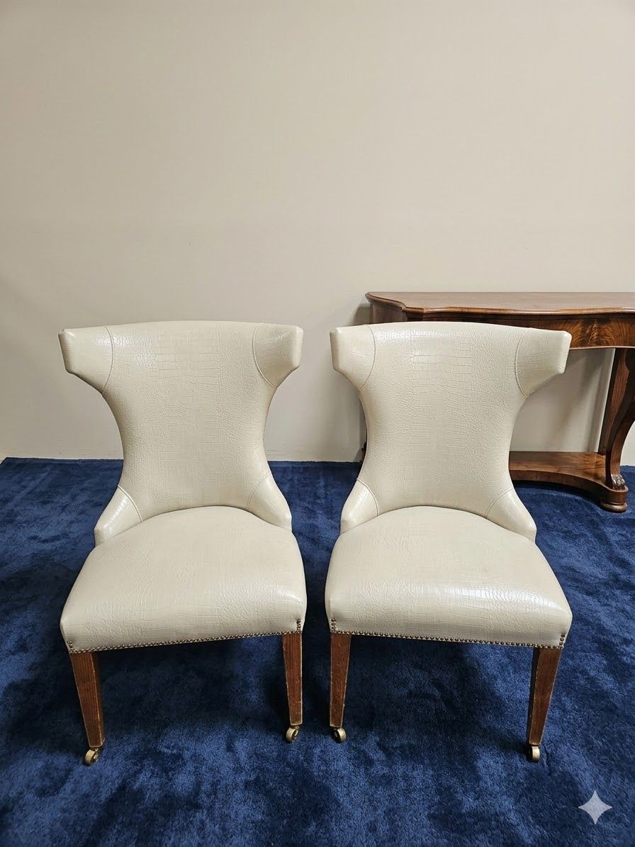 Lot 909: * Pair dining chairs features cream-coloured upholstery with a distinct flared backrest design