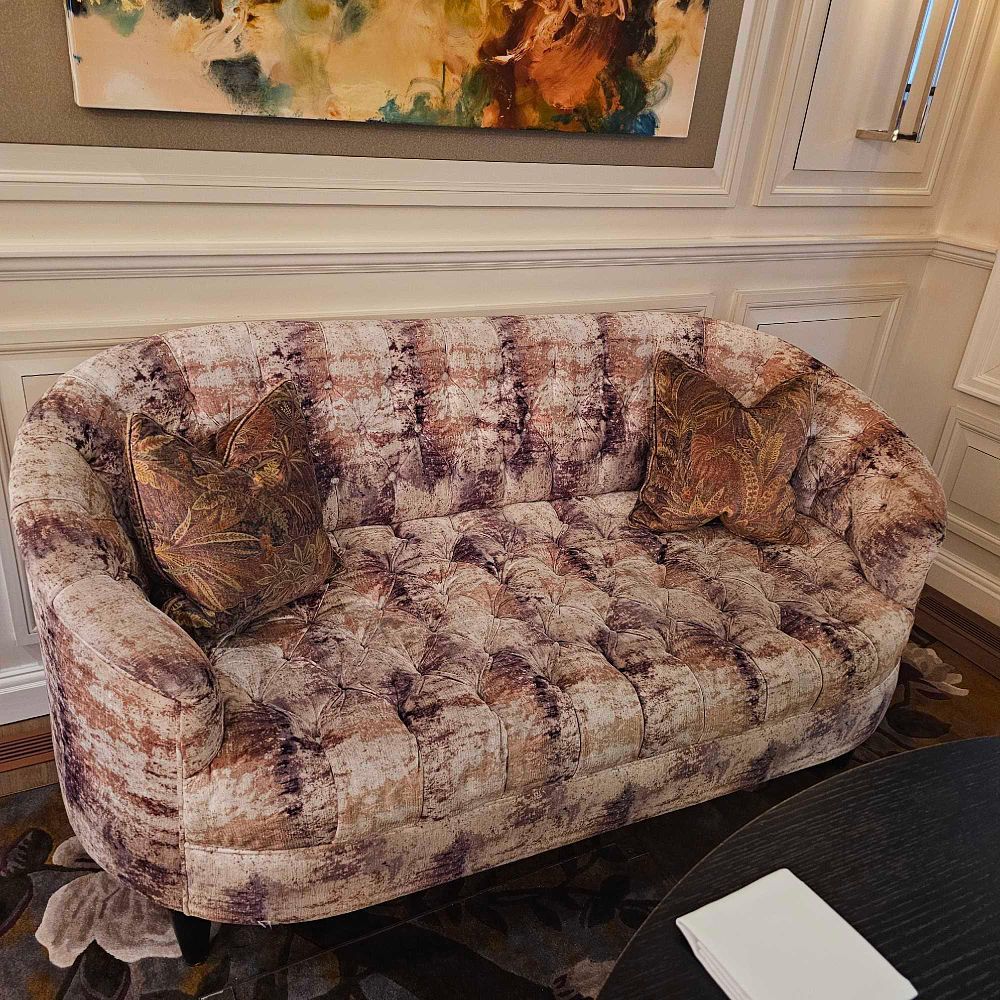 Lot 1132: * A curved elegant sofa with round sides and rolling back Mottled or Marbled pattern upholstered