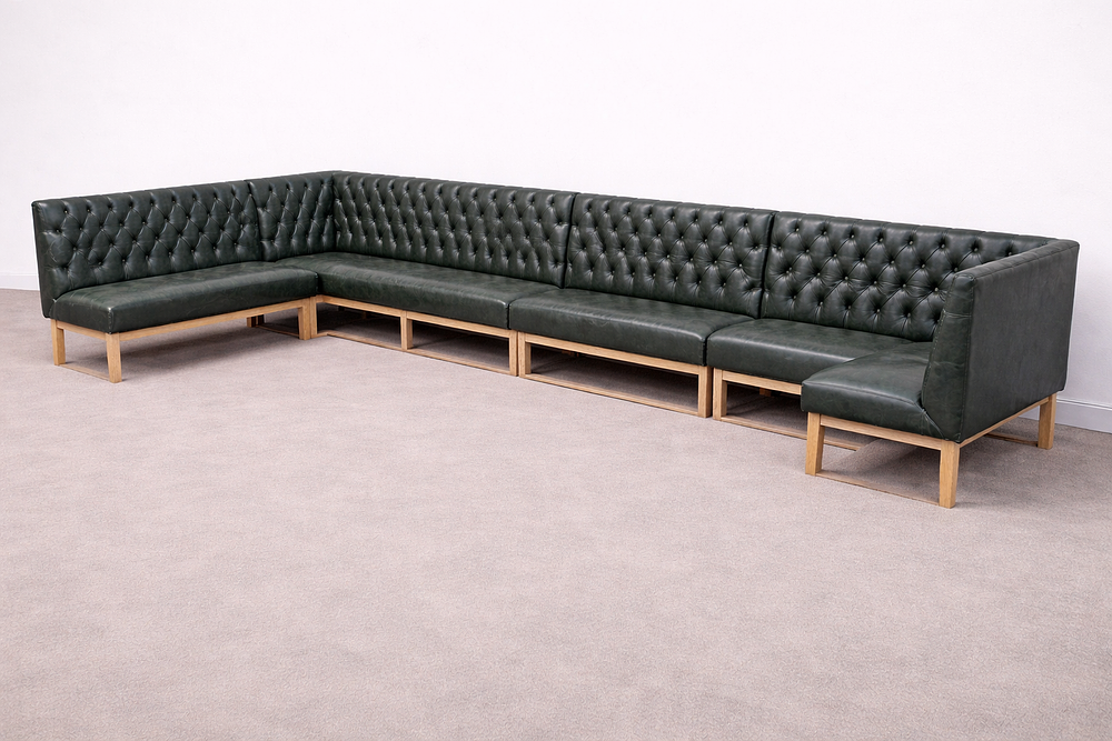 Lot 253: * A large modular sectional banquet sofa upholstered in dark green leather