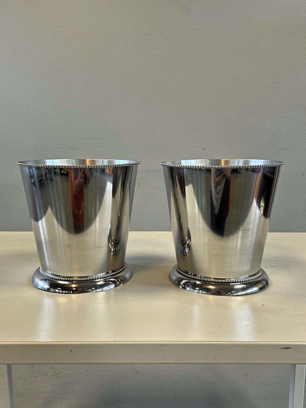 Lot 301: A matching pair of contemporary stainless steel ice buckets / wine coolers