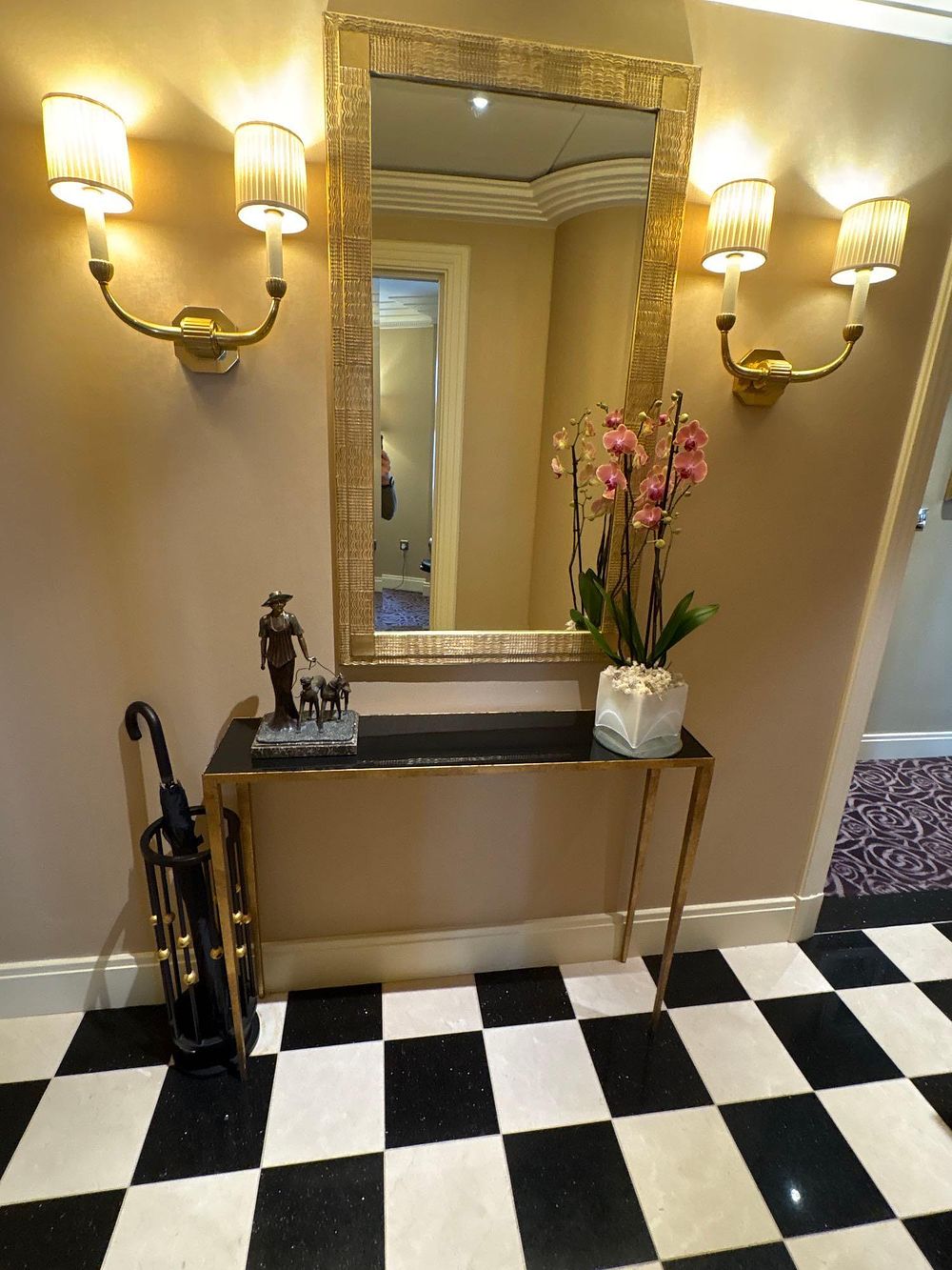 Lot 530: A pair of twin arm polished brass wall sconces complete with shades