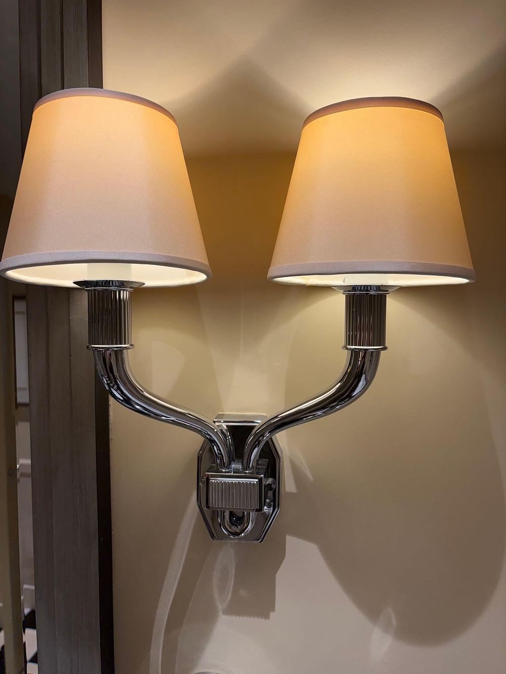 Lot 1129: A Pair of Contemporary Art Deco Style Polished Nickel Twin-Arm Wall Sconces