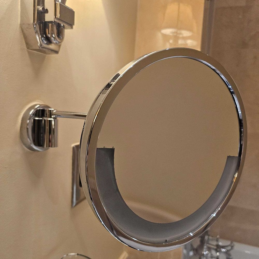 Lot 3123: A wall-mounted, illuminated vanity and shaving mirror removed from a guest bathroom at