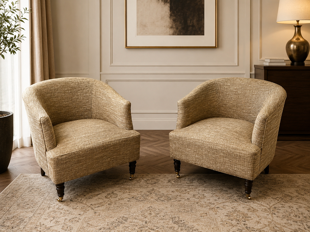 Lot 1628: A pair of Mid-Century Style Fabric Tub Armchairs Inject a touch of retro charm and a bold pop of