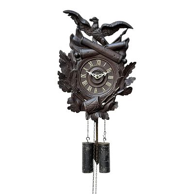 Military cuckoo clock with eagle and cannons, Black Forest, circa 1900. Carved Black Forest wall 