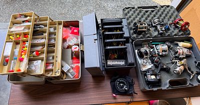 A Collection of Vintage and Modern Fishing Equipment Featuring Abu Garcia, Shimano, and Penn Reels. 
