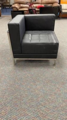 Modular Black Tufted Corner Chair. what appears to be white paint is on the seat, no tares are 