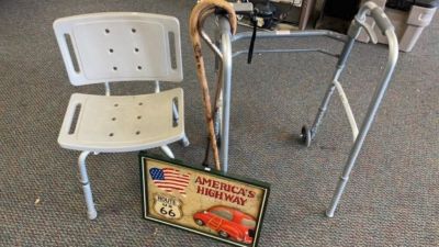 2 Walking Canes, Route 66 Sign, Shower Chair,. and a walker