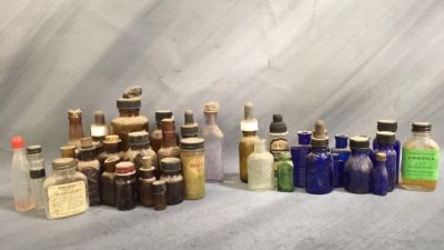 35+ antique bottle with lots of labels most have. caps couple have liquids smallest is 1 inch 
