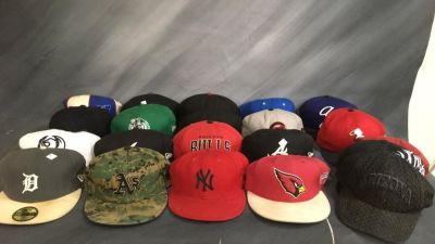 21 mostly fitted size 7 1/8. Bulls, NY, Cardinals. 21 hats mostly fitted hats. See photos