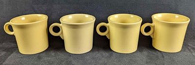 4 Yellow Sunflower HLC Fiesta Mugs. Each is approx 5" x 2 1/2" x 3 1/2" and together they weigh 