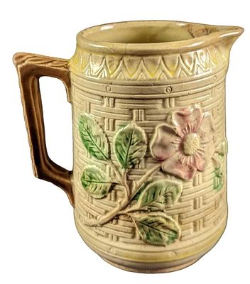 Vintage Ceramic Floral Pitcher. Its maker and date of creation are unknown. The pitcher is 