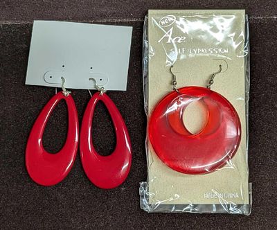 2 Set Of Red Plastic And Lucite Red Earrings. This lot includes: 
(1) Set Of Sealed Opaque New 