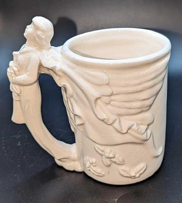 McConnell Angel Coffee Ceramic Mug. By the Talus Corp. The mug is approximately 5" x 3" x 5" 