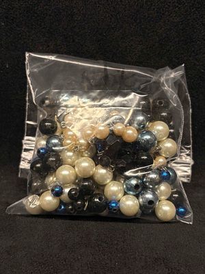 4.5 OZ of Black Pearlescent and Blue Loose Beads. This lot contains loose and/or broken pieces 