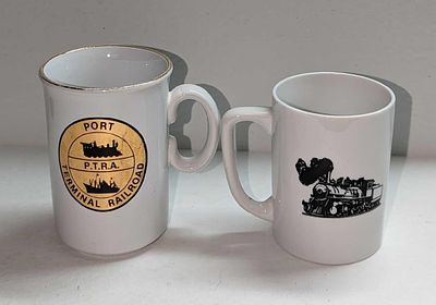 2 Vintage Port Terminal Railroad Ceramic Mugs. The smaller mug is approx 4 1/4" x 2 7/8" x 3 