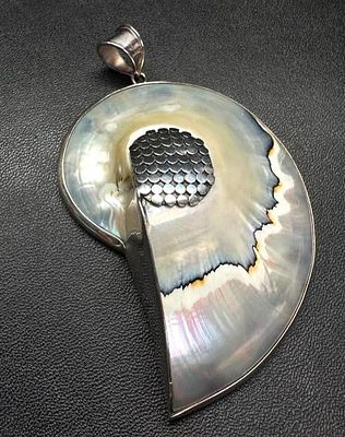 925 Sterling Mother of Pearl Ammonite-Shaped Pendant. This piece of jewelry has been tested and 