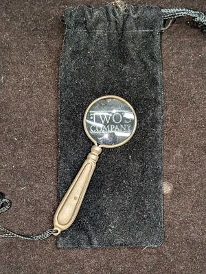 Two's Company Mini Magnifying Glass. It comes in a bag that is approx 2 1/2" x 5 3/4" and it 