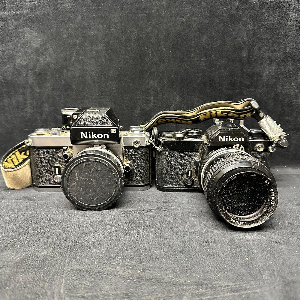 Lot 325: Pair of Vintage Nikon 35mm SLR Film Cameras With Nikkor Lenses