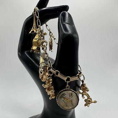 14K Gold Charm Bracelet Clown Disney Clock Heart Grad Cap Theme. This item is in good pre-owned 