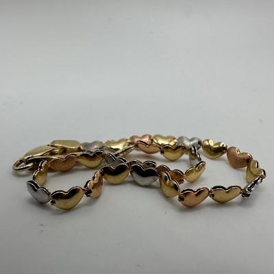 Tri-Tone Stampato Style Heart 14K Gold Bracelet. This item is in good pre-owned, previously 