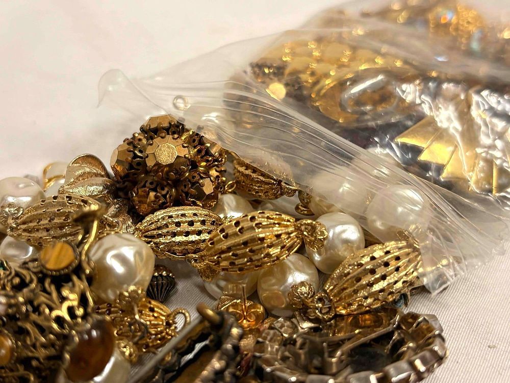 10 Plus Ounces of Gold Charms, Beads, Broken Costume Jewelry and More. This lot contains over 11 
