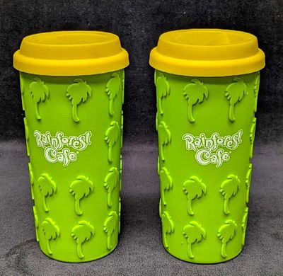 2 Rainforest Cafe Silicone Grip Palm Tree Coffee Tumblers A. Both are ceramic with a silicone 