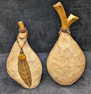 2 Resin Shell Layered Mantel Vases C. This appears two resin or plaster vases covered with a 