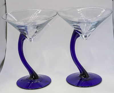 2 Cobalt Blue Stemmed Martini Glasses. The maker and date of creation is unknown. Each is 