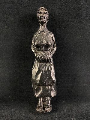 Black Resin Statue of a Woman Cast black resin statue of a woman in 19th century clothes. Shows 