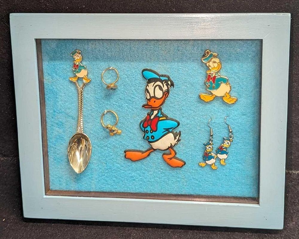 Lot 288: A Lot of 6 Vintage Donald Duck Framed Collectibles Earrings Rings Spoon Charm Pendant Figure