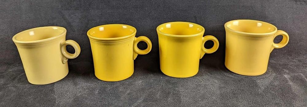 Lot 102: 4 Yellow Sunflower HLC Fiesta Mugs