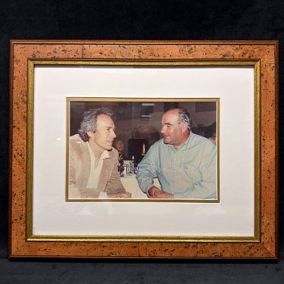 Framed Photograph of Michel Roux with Clint Eastwood. Framed color photograph depicting liquor 
